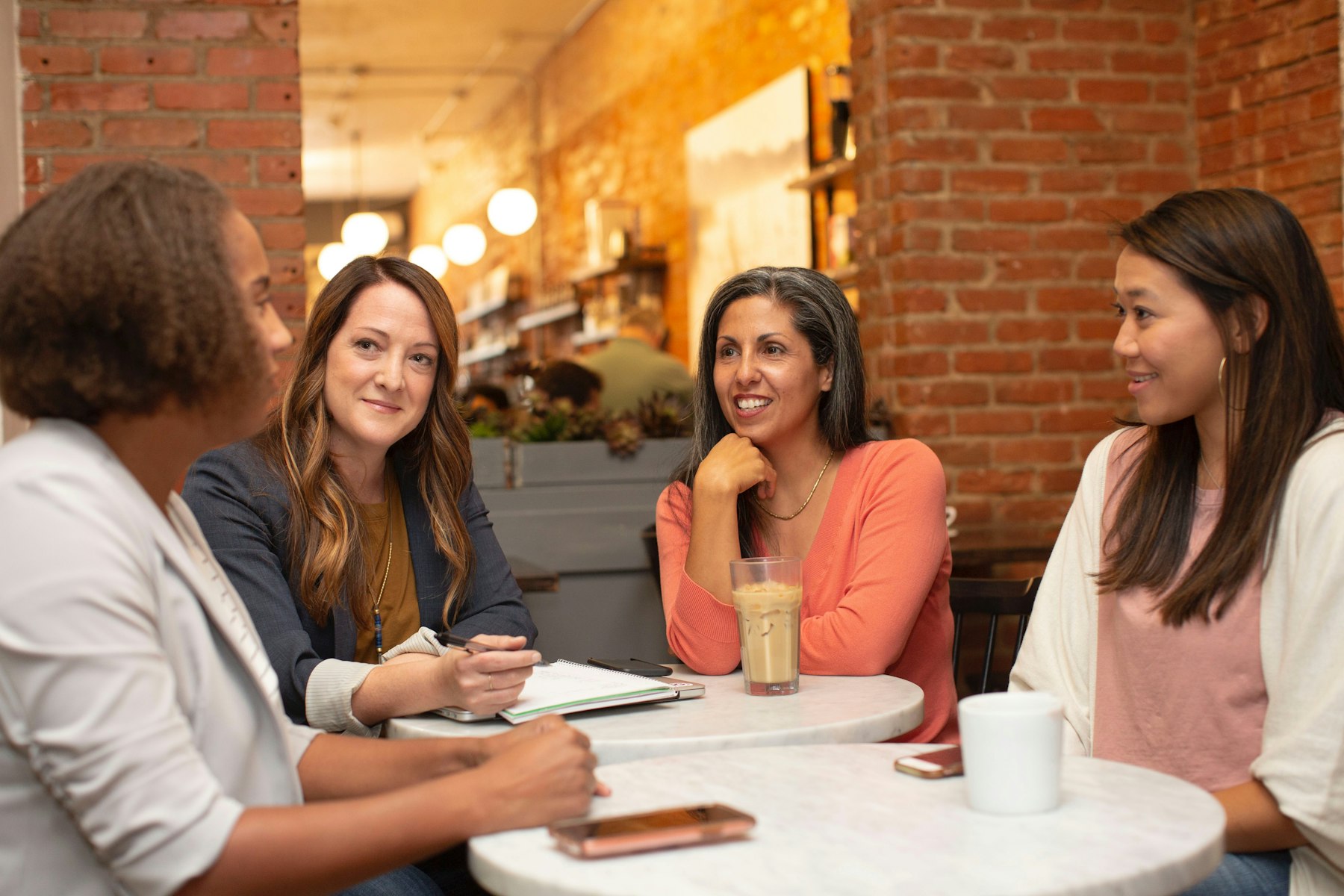 A small group of professionals talking around a café table